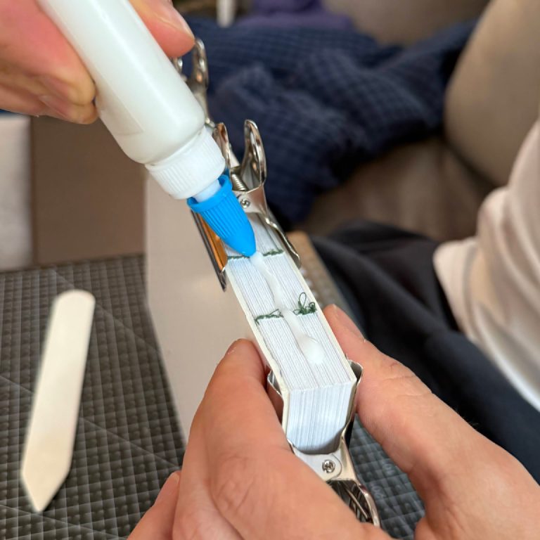 Applying glue to the spine in a rudimentary “press” setup.
