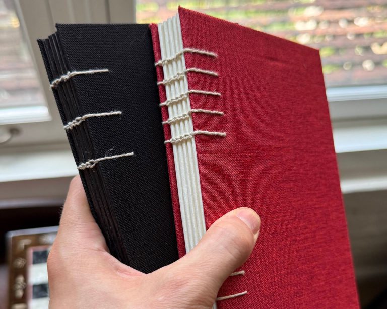 The exposed stitching connecting the signatures to the cover boards.